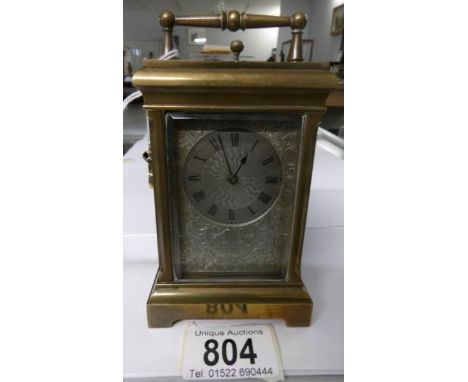 A brass repeater carriage clock with silver dial, marked E W Streeter, 18, New Bond Street, London, in working order and with