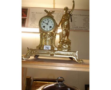 A French gilded mantel clock surmounted figure