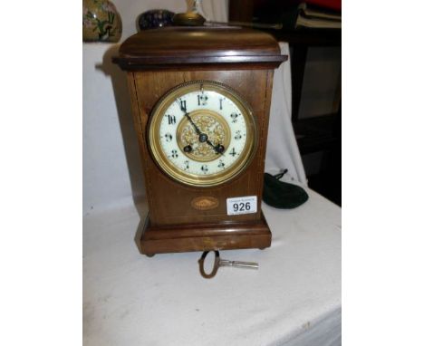 A mantel clock with shell inlay
