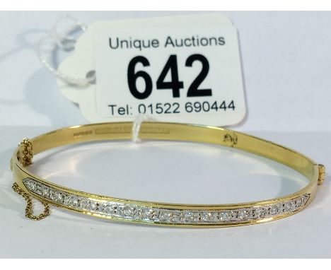 An 18ct gold bangle set with 17 brilliant cut diamonds, 11.17 gms