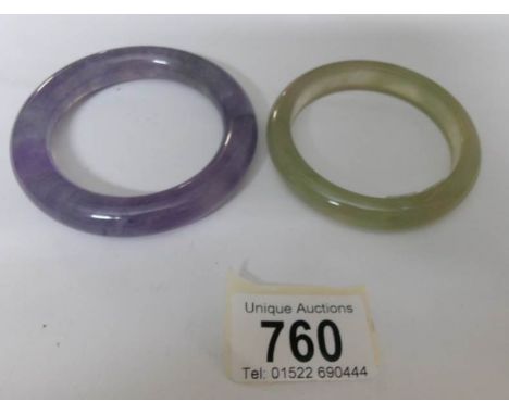 A clear jadeite bangle with flat inside together with a lavender jadeite bangle