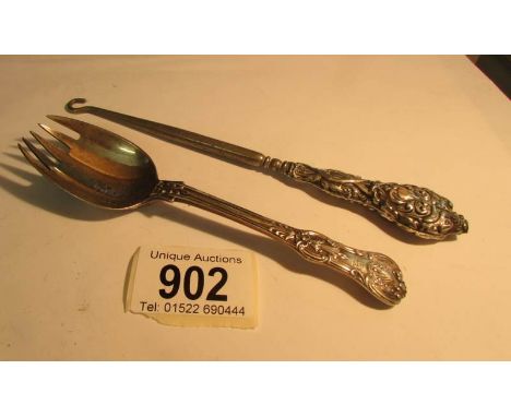 A silver handled button hook and a silver cake spoon,,