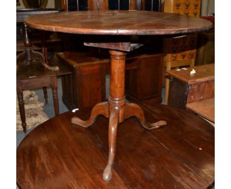 {} An 18th century oak bird cage platform tripod table on a gun barrel support, 90cm wide 