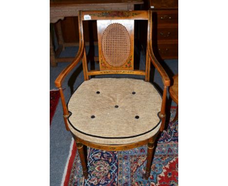 An Edwardian satinwood and polychrome painted armchair with caned seat and squab cushion, 50cm wide 