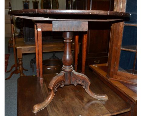 ^ A George III mahogany tripod table, with flip top above a bird cage platform, baluster support and three cabriole legs, 92c