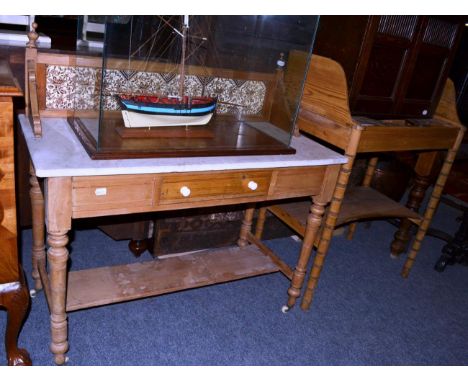 A Regency pine washstand, early 19th century, with a three quarter gallery back above three apertures, raised on bamboo simul
