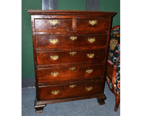 An 18th century oak six drawer straight front chest, the moulded top above two short and four long graduated drawers, raised 