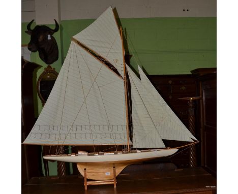 A large scale model pond yacht with linen sail and a cream painted hull, maximum width 170cm