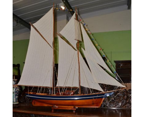 A 20th century scale model of a steam ship with linen sail and blue painted hull, maximum width 190cm