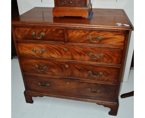 A George III mahogany straight fronted chest of drawers, with a moulded top above two short and three long graduated drawers,