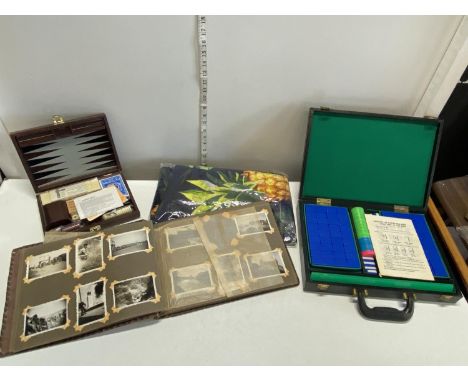 A cased mah-jong game with a vintage photograph album and a games compendium