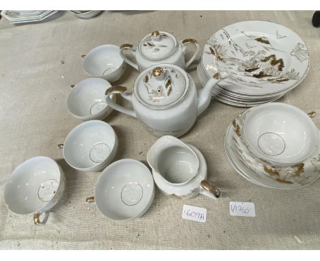 A Japanese fine egg shell porcelain tea service with Geisha to base of cups, shipping unavailable