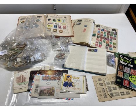 A selection of vintage stamp albums and loose stamps