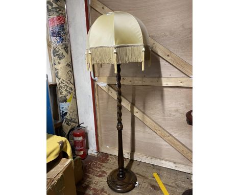 A good quality vintage wooden floor lamp with a barley twist column and shade. No shipping