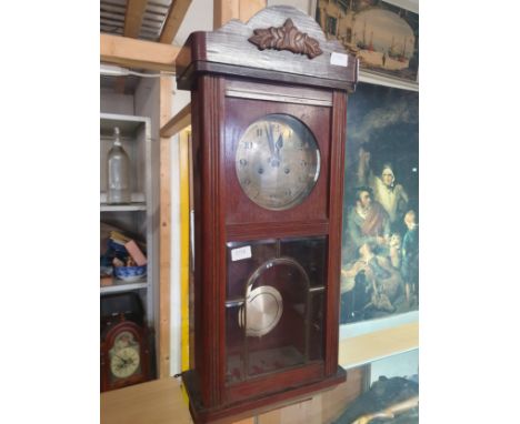 A vintage wooden cased wall clock with key and pendulum, shipping unavailable
