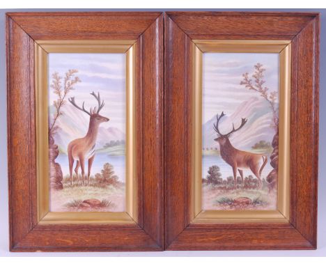 A pair of ceramic plaques, each decorated with a stag within a mountain landscape, 29 x 14cm.