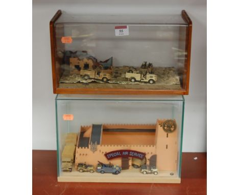 A scale model of a fort with diecast support vehicles, in glazed display case, w.30cm; and one other with army jeeps (2)