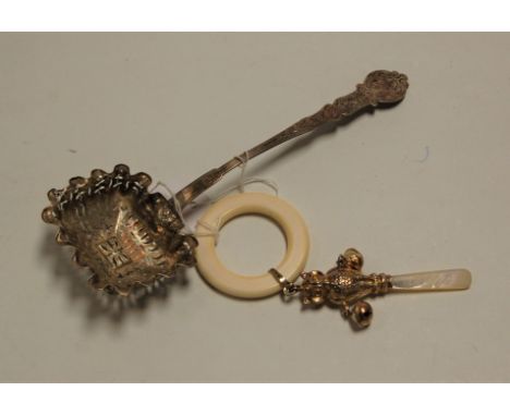 A filled silver baby's rattle in the form of an owl, having mother of pearl handle; together with an early 20th century Frenc
