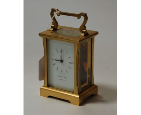 A contemporary brass carriage clock as retailed by Garrard &amp; Co having single barrel going movement, height 12cm (handle 