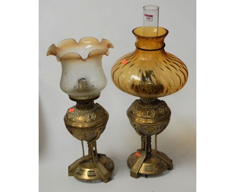 A pair of Victorian style cast brass lamps, each fitted for electricity and disguised as oil lamp, with differing shades