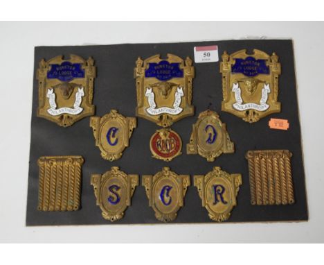 A display of pressed brass and enamel masonic badges, to include three for the Hunston Lodge No.3614