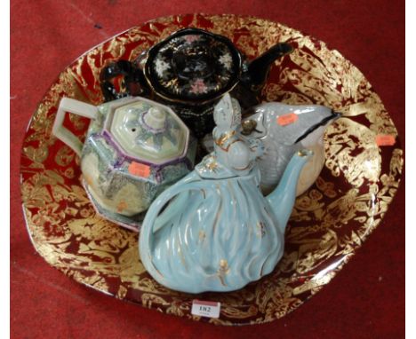 Four novelty teapots to include lustre glazed example together with a large ruby glass bowl