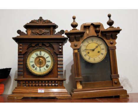 A circa 1900 American oak cased mantel clock, having Ansonia spring-driven movement; and one other (2)