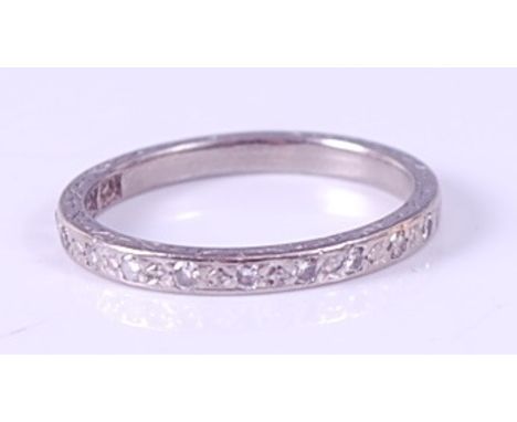 A white metal diamond half-hoop eternity ring, the twelve round brilliant cut diamonds each measuring approx 1.7mm, total wei