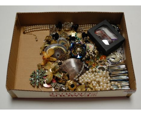 A box of miscellaneous costume jewellery to include faux pearl necklace, various brooches, bangles etc