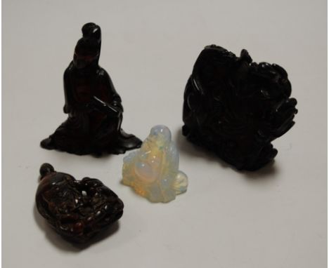 A polished resin figure of Guanyin(?), in seated pose with scroll in hand, h.11cm; together with a carved opalescent resin fi