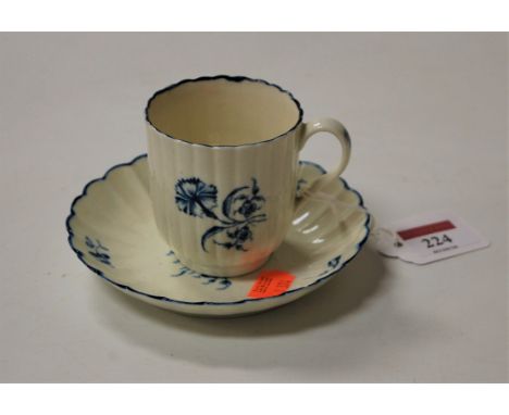 A mid-18th century Worcester porcelain blue and white coffee cup and saucer, decorated with floral sprays, hatched crescent C