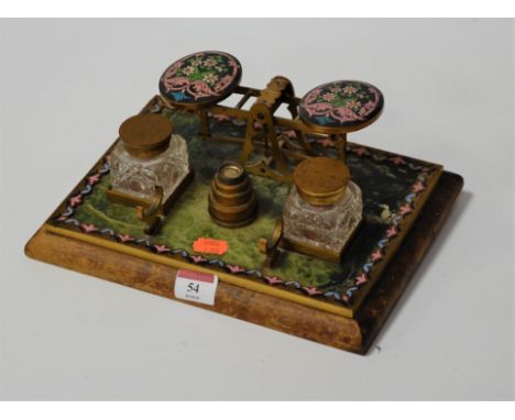 A circa 1900 marble and brass desk stand, having champlevé enamel inlays, inset with balance scale, graduated weights, and tw