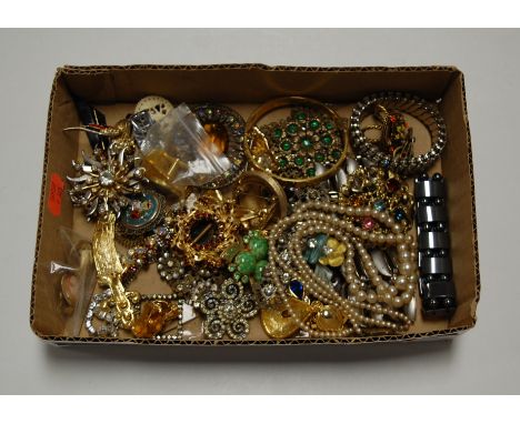 A box of miscellaneous costume jewellery to include gold plated bangle, faux pearl two-string choker, various brooches etc