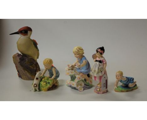Four various Worcester figures, each modelled by Dorothy Doughty, being Spain, May, Michael, and two babies; together with a 
