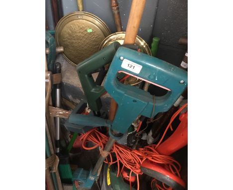 A bundle of garden tools including rake and strimmer 
