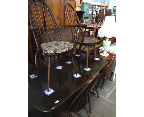 An Ercol dark elm and beech refectory table and six chairs. 