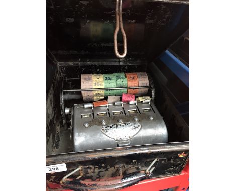 A bus conductor ticket machine with unused ticket rolls in tin case. 