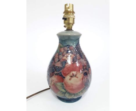A Moorcroft pottery lamp base decorated in Finches pattern with birds amongst fruit, height (excluding fitting) 20cm. Conditi