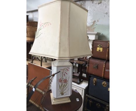 A pottery table lamp with floral decorated sides and shade. 