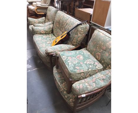 An Ercol four piece ash suite comprising settee, two armchairs and foot stool. 