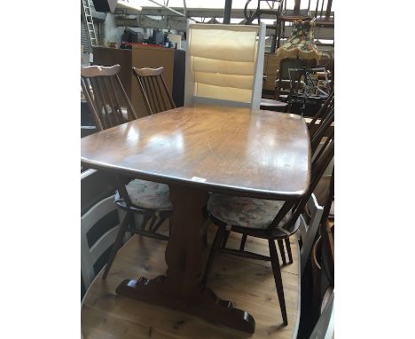 An Ercol dark elm and beech refectory table and four chairs. 