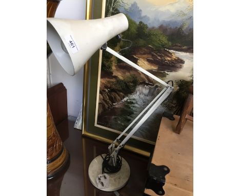 A white angle-poise lamp. 