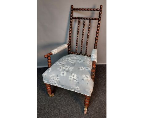 Bobbin-turned chair [in the style of Liberty] with cushioned upholstered seat, raised on front bobbin-turned legs and back sq