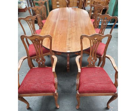 Reproduction pine table, the oval surface raised on two baluster columns ending in out swept tri legs, together with six chai