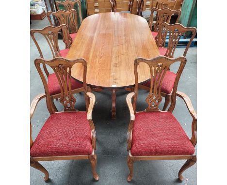 Reproduction pine table, the oval surface raised on two baluster columns ending in out swept tri legs, together with six chai