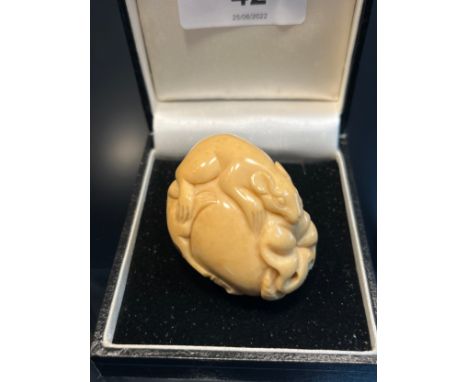 A Japanese hand carved tagua nut netsuke in the form of two rats on a piece of fruit. [4.5cm in length] 
