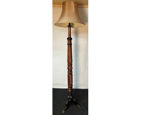 Antique standard lamp, the hand carved column raised on three out swept legs [216cm high] 