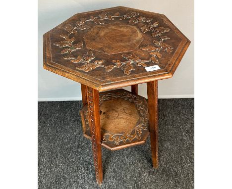 Octagonal arts and crafts table, carved oak leaves and acorns to the top [71cm high] 