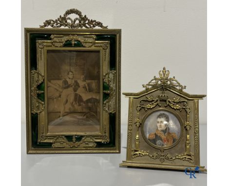 A large bronze and green enamelled LXVI style frame in the manner of Fabergé and a bronze empire style frame with miniature, 