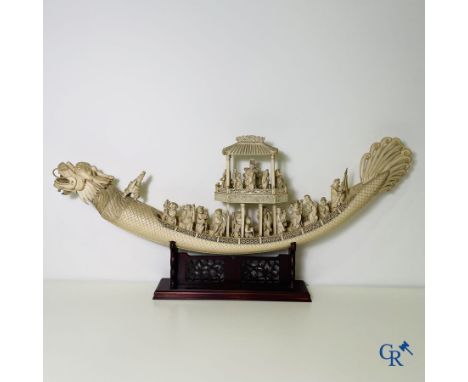 Asian Art: A large Chinese ivory dragon boat consisting of a central carved tusk, richly decorated with figures, and as a fig